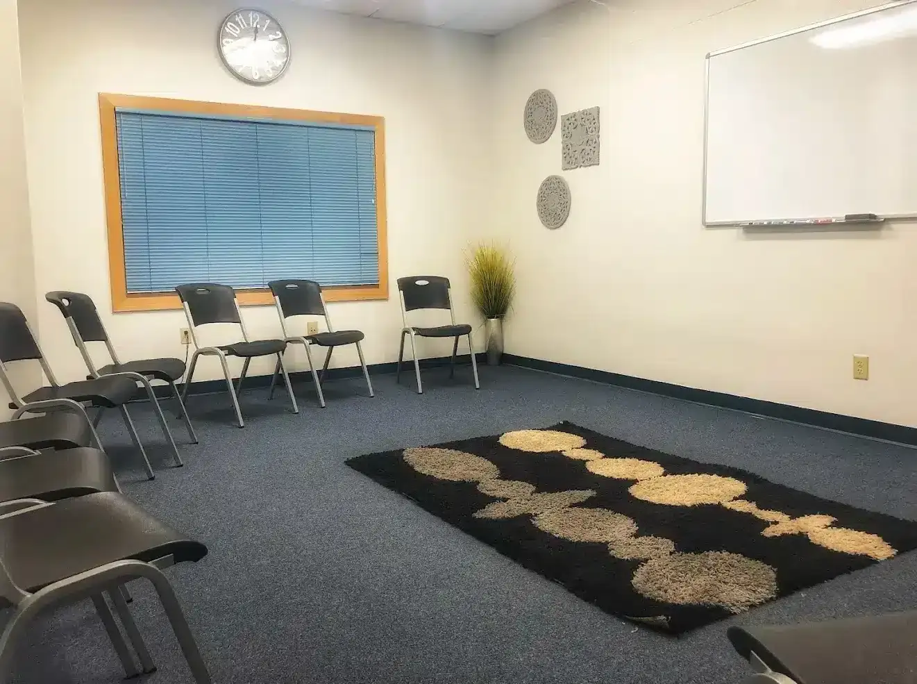 Group therapy room at Liberty Bay Recovery Center, chairs in circle, whiteboard