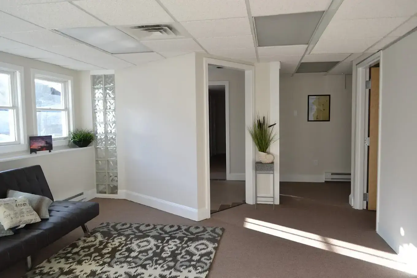 Liberty Bay Recovery Center Portland common room with seating, rug, and plant