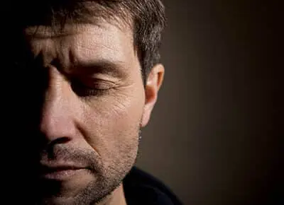man closing his eyes and deciding to go to a ptsd treatment center